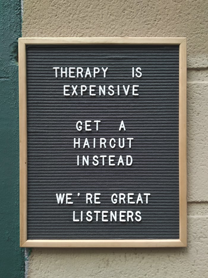 brown-wooden-frame-sing-board-close-up-photography-2528695 Beauty & Barber Branding Funny hair salon sign suggesting haircuts over therapy for listening.